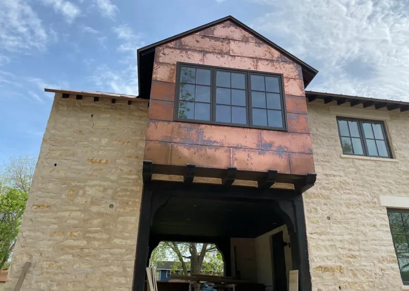 Copper metal panel facade on a stone building for Roof Repair in Eloy